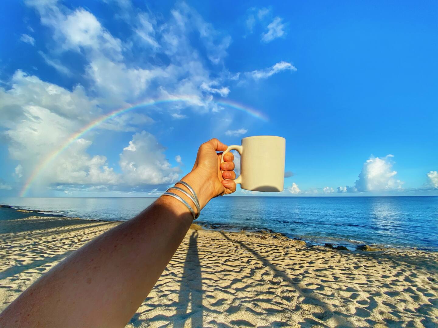 Rainbows in my coffee on the beach